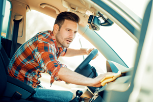 Man cleaning inside of a car